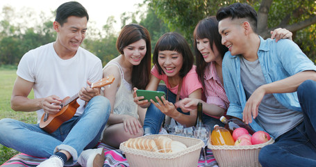 Youngster friends go picnic together at park