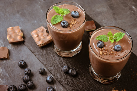 Chocolate  smoothie (pudding) with mint  in  glasses   on a grey background.