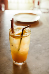 glass of apple tea and cinnamon stick