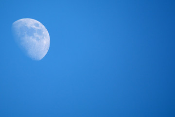 Moon in blue sky with space for text