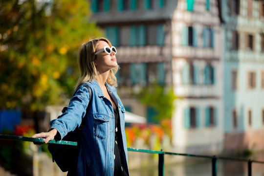 Young girl in jeans jacket and sunglasses on street of Strasbourg, France. Autumn season time