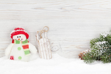 Christmas snowman and sledge toys and fir tree branch