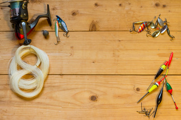 Tackles for fishing on a wooden table.