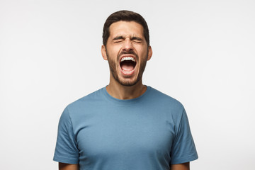Angry man, rage concept. Closeup portrait of screaming with closed eyes crazy young male isolated,...