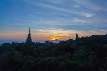 Fotobehang sunset between Noppamethanedol and Noppapol Phumsiri pagoda on Doi Inthanon national park..Doi Inthanon national park is the highest mountain of Thailand © Narong Niemhom