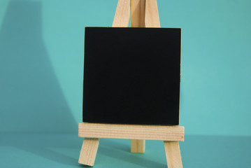 Mini blackboard chalkboard with copy space, isolated on blue background.