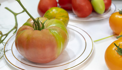 A large tomato on a plate.