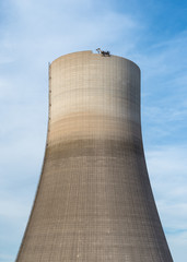 Demolition of the atomic chimney. Remote controlled excavator with shears works from above.