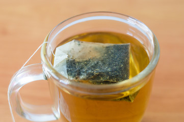 A cup of nettle tea with bag.