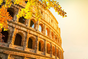 ruins of Colosseum at sunrise light in Rome, Italy at fall