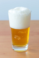 Glass with beer and foam.
