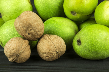 many walnuts on the background of dark wood in the skin and without