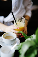 Glass of juice and cup of coffee on a table at restaurant