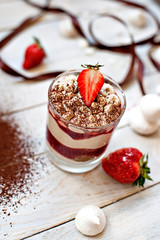 Sweet white dessert of tiramisu with fresh red berries of strawberry