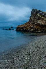 Obraz premium The photo of the stone on the beach on the long exposure