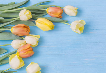 yellow tulips on wooden background © Maya Kruchancova