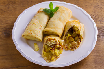 Apple cinnamon crepes. Pancakes with caramelized apples and cinnamon