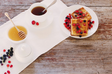 breakfast with berries on old wooden table