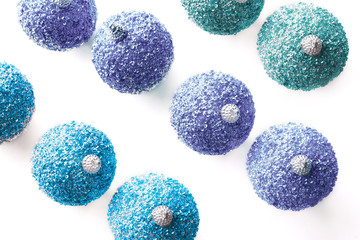 Christmas decor. Silver-blue, silver-purple balls of sequins on white background.Isolated