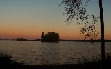 sunset at lake with tree and island