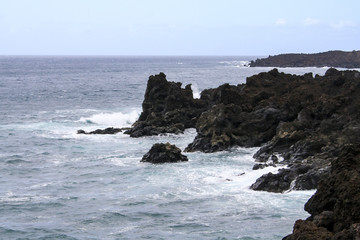 Fototapeta na wymiar The infinity ocean licking the rocks on the coast of Lanzarote, Canary Islands