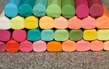 Coloring waxy pencil sticks in many different colors stacked up