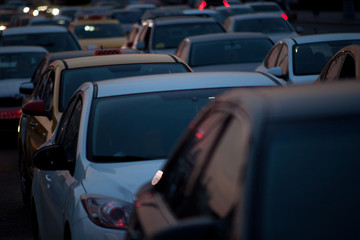 cars stand in traffic at rush hour in the big evening modern city