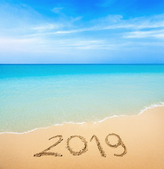 Fototapeta na wymiar 2019 written on sandy beach