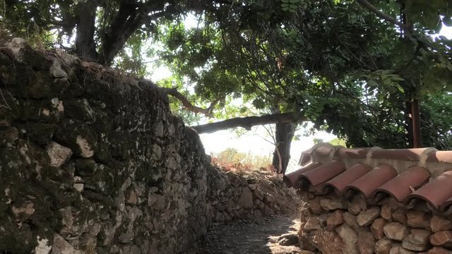 Alanya, Antalya, T&uuml;rkei - 07.09.2018: Burganlage aus dem Mittelalter an der Mittelmeerk&uuml;ste, Fu&szlig;pfad zwischen Mauern mit Dachziegeln, mit Originalton: Grillenzirpen