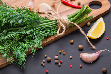 A bunch of fresh dill on a black board