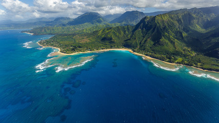 View of the beaches and mountains of Kauai's north coast with Tunnels Beach and the reef from Haena...