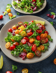 Fresh Cherry Tomato mix salad with lettuce, lemon, lime, black pepper and sea salt. healthy food