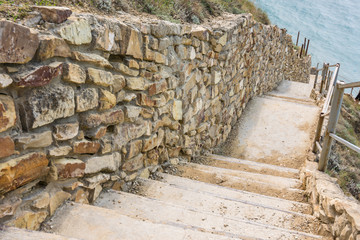 Picturesque steps with a stone fence descending to the sea