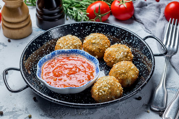 Chicken croquettes with tomato sauce