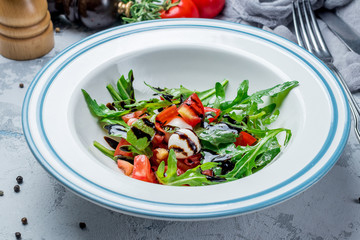 Salad with tomato arugula and mozarella cheese