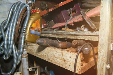 Old instruments on the rack in the old workshop with lens flare