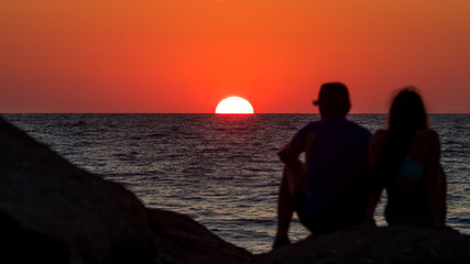 Couple on the beach at sunset