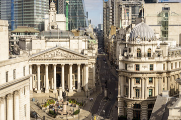 Fototapeta na wymiar building of Royal Exchange in London near Bank underground station and Aerial view of skyscrapers of the world famous bank district of central London on the background
