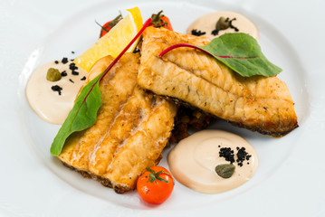 fried fish fillet with vegetables with parmesan sauce