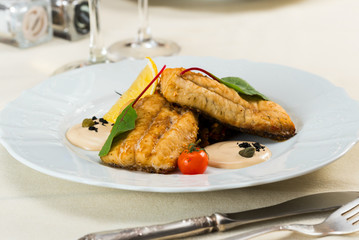 fried fish fillet with vegetables with parmesan sauce