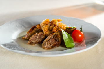 homemade smoked hot pork sausage with vegetables and fried onions