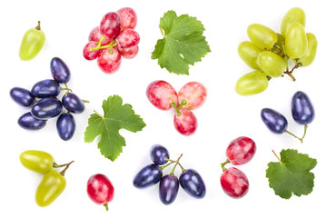 green pink and blue grapes with leaves isolated on the white background. Top view. Flat lay pattern