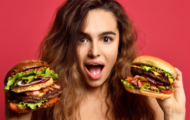 Woman compare big beef burger sandwich and huge cheeseburger with hungry mouth happy shouting on...