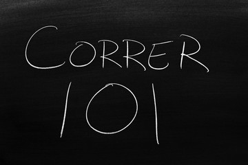 The words Correr 101 on a blackboard in chalk.  Translation: Running 101