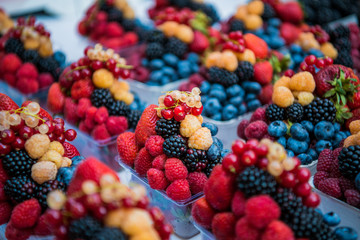 Fruits, berries and vegetables on the counter at the street market.