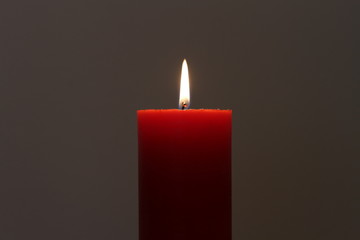 red candle in the dark