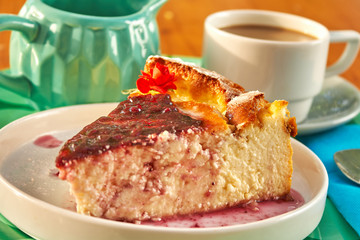 Delicious homemade cheese cake with strawberry jam and a cup of coffee