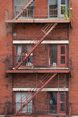Fototapeta na wymiar Close-up view of New York City style apartment buildings with emergency stairs along Mott Street in the Chinatown neighborhood of Manhattan NYC.