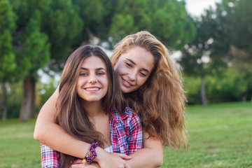 Fototapeta premium Young women enjoying and laughing in the park on a sunny day. 