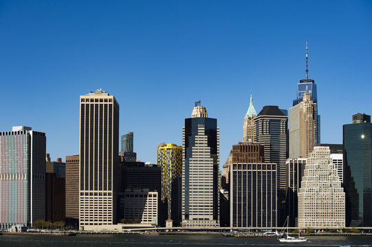 Amazing view of the Manhattan skyline seen from the Brooklyn Bridge Park. Sunny day of October in New York. USA.